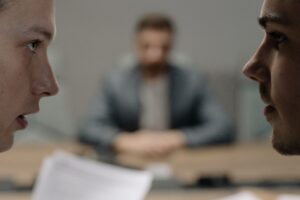 Close-up of two men in a serious discussion at a business meeting.